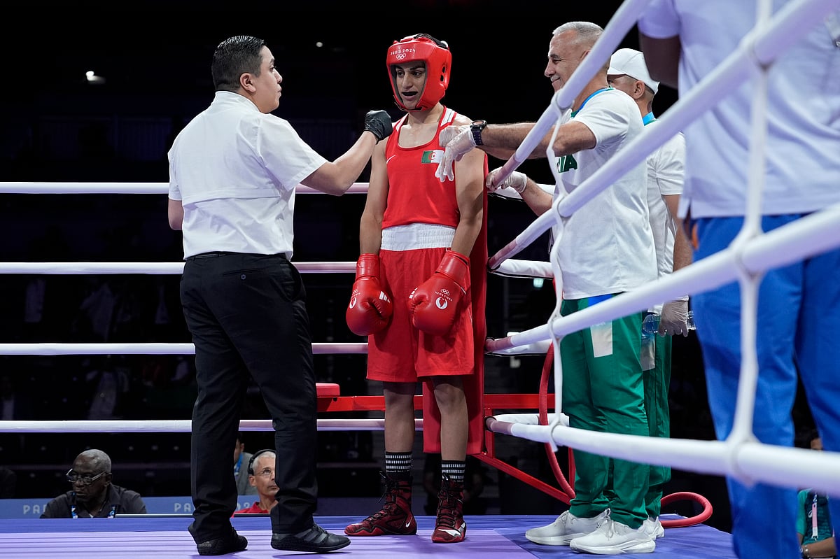(AP Photo/John Locher) : Algeria's Imane Khelif prepares to fight Italy's Angela Carini in their women's 66kg preliminary boxing match at the 2024 Summer Olympics, Thursday, Aug. 1, 2024, in Paris, France. 